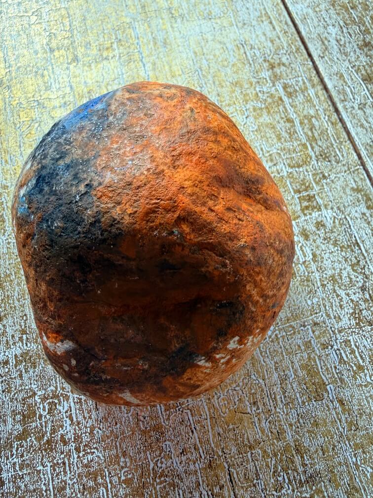 Painted stone No. 14, decorated as: Orange, black, blue splodge