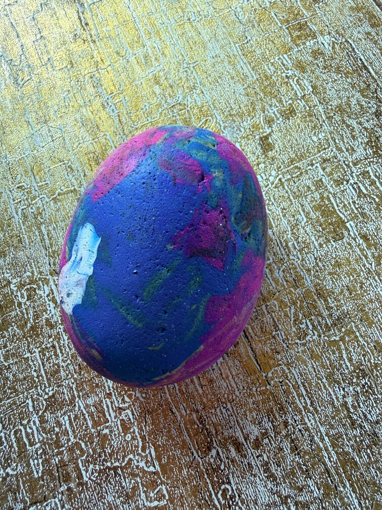 Painted stone No. 15, decorated as: Pink, blue splodge, white dot