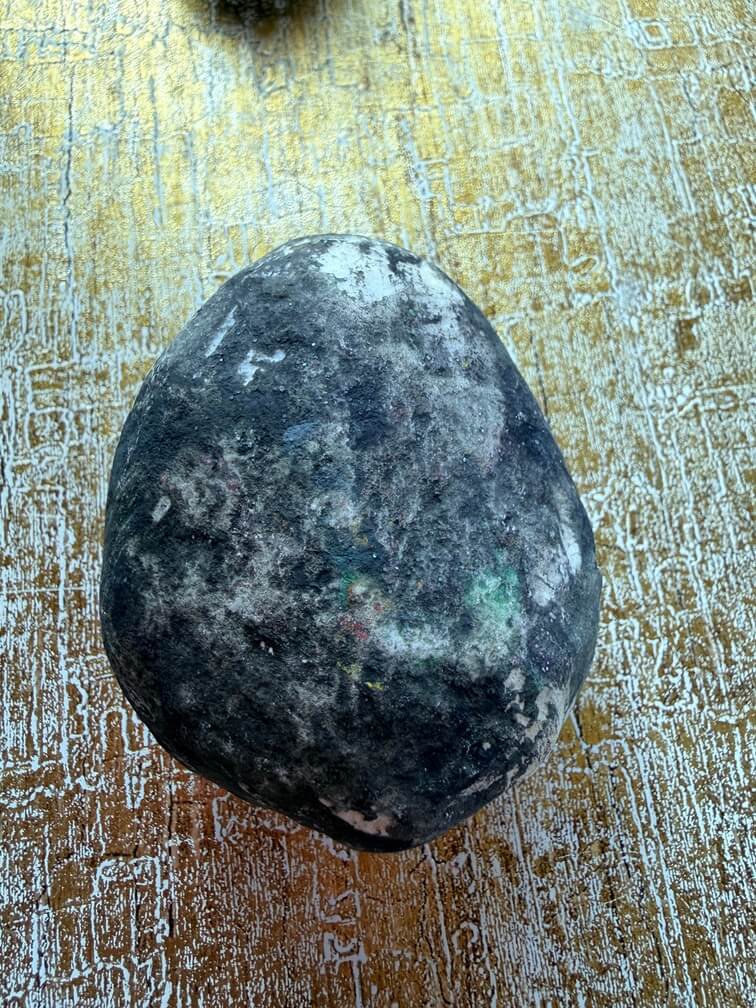 Painted stone No. 25, decorated as: Black with white splashes