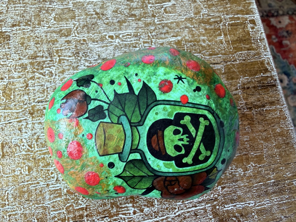 Painted stone No. 27, decorated as: Poison bottle with red dots