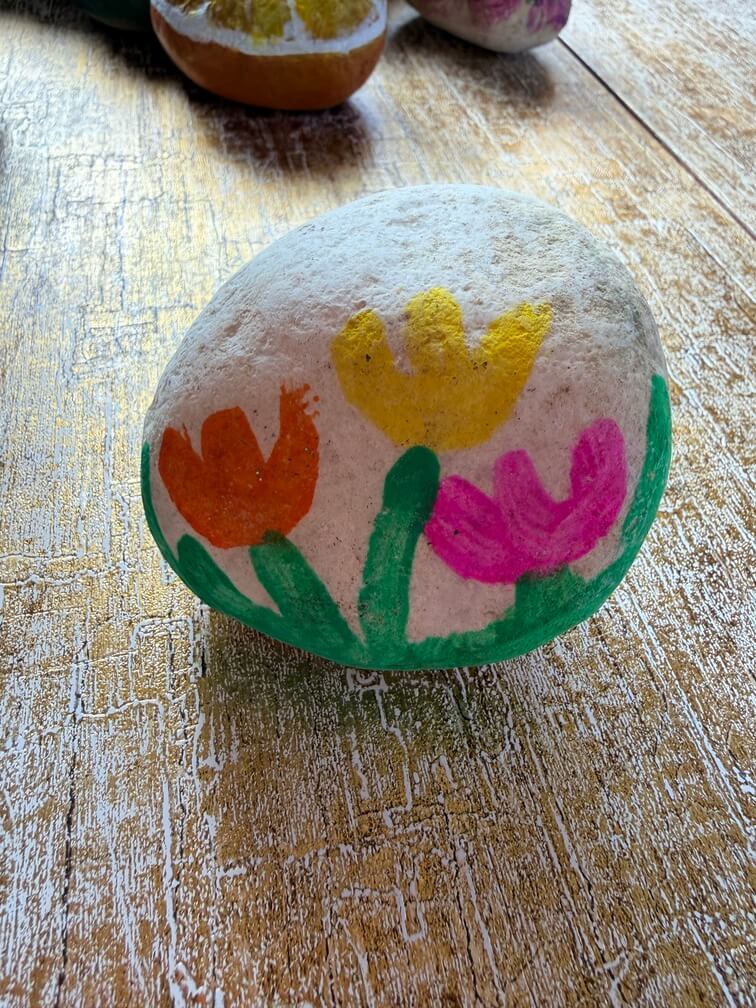 Painted stone No. 30, decorated as: Tulips orange yellow pink