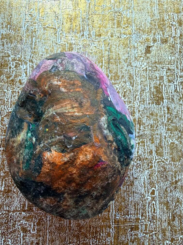 Painted stone No. 31, decorated as: Black & orange with pink splodge