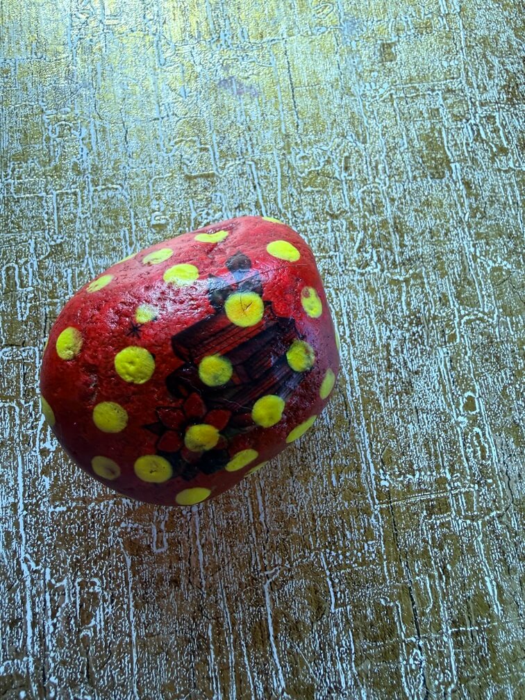Painted stone No. 33, decorated as: Small red with yellow dots