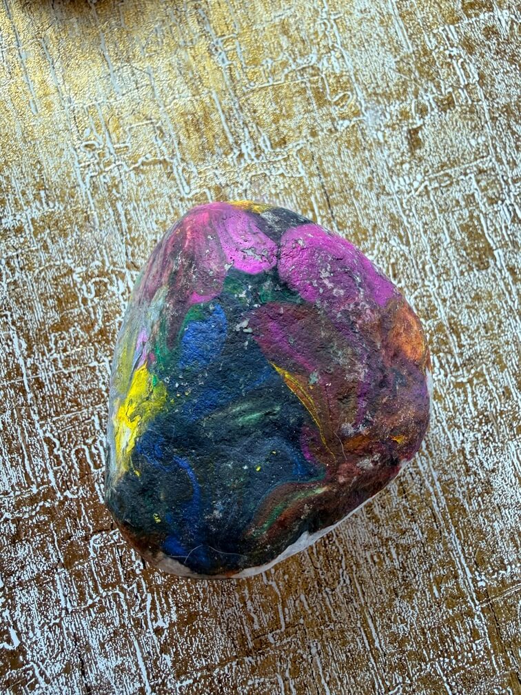 Painted stone No. 37, decorated as: Galaxy with yellow, pink, orange splodges