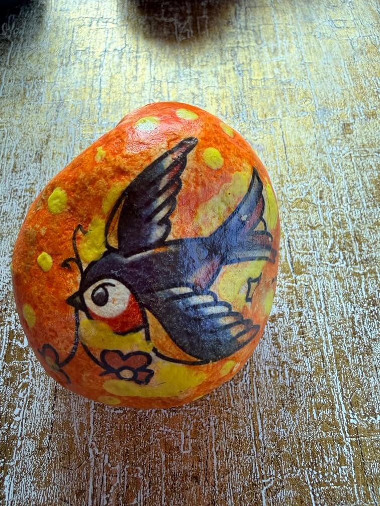 Painted stone No. 38, decorated as: Orange, yellow dot bird