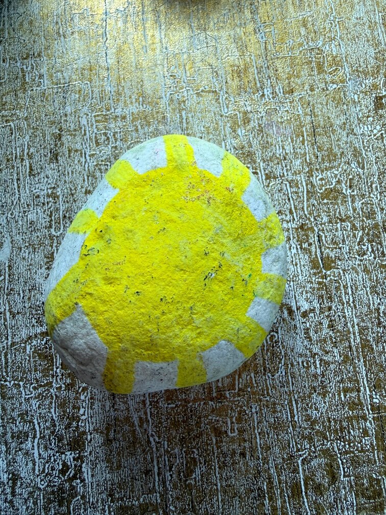 Painted stone No. 39, decorated as: Yellow sunshine