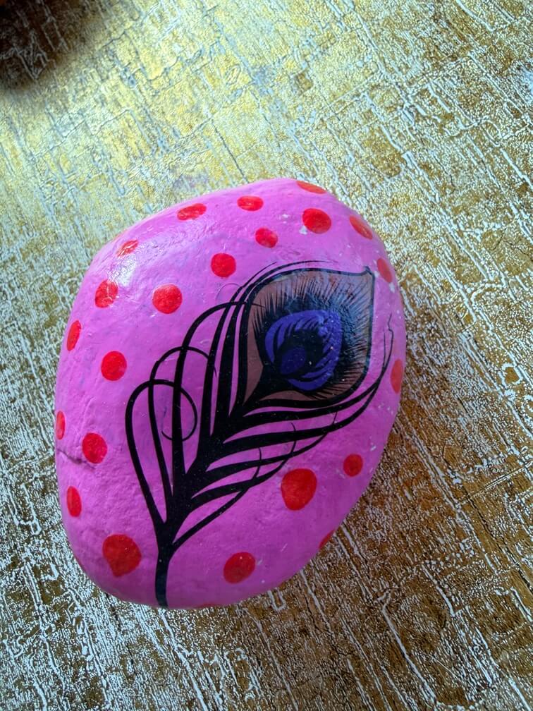 Painted stone No. 45, decorated as: Pink red dot feather