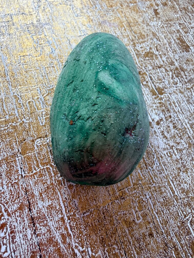 Painted stone No. 49, decorated as: Little green tadpole with sparkle
