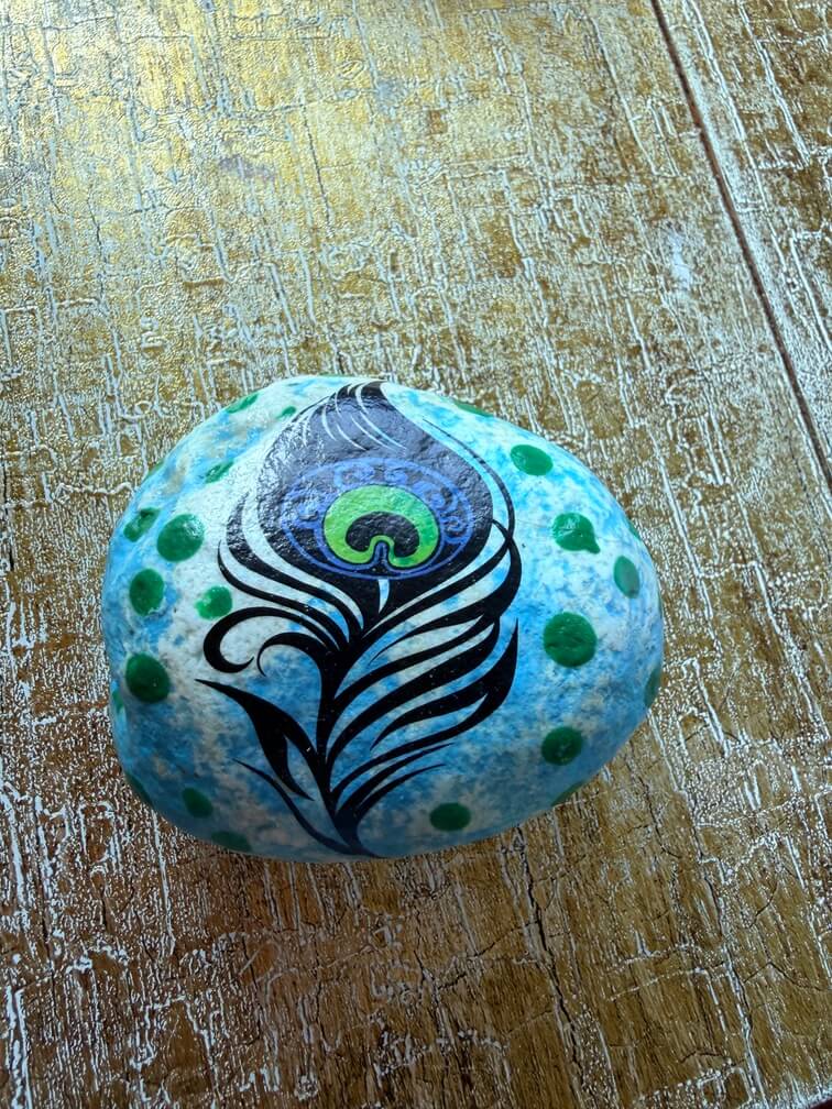 Painted stone No. 50, decorated as: Blue green dot feather