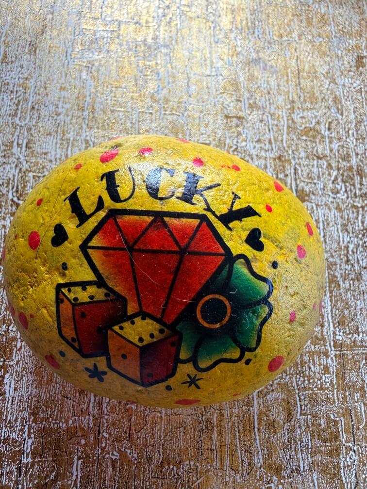 Painted stone No. 52, decorated as: Yellow red dot lucky