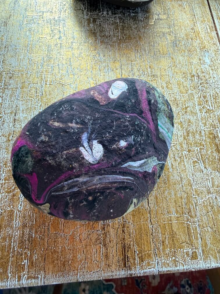 Painted stone No. 56, decorated as: Large galaxy with shooting stars and pink lines