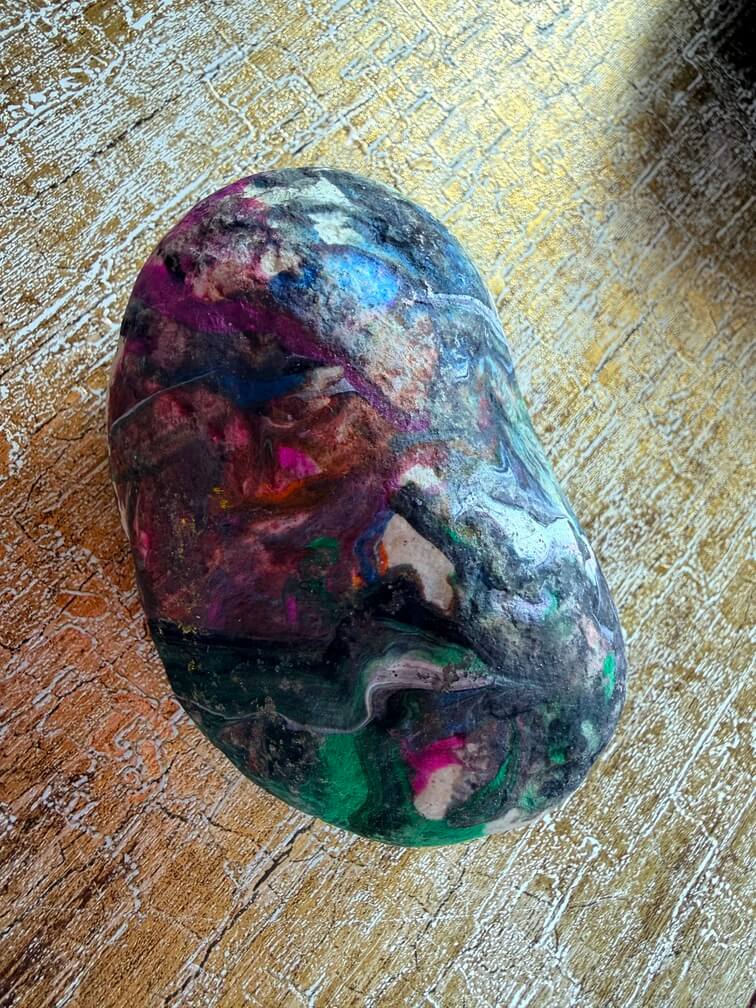 Painted stone No. 58, decorated as: Splodgy black, with green end, white line
